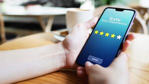Person holding a phone with stare ratings on it for reviews