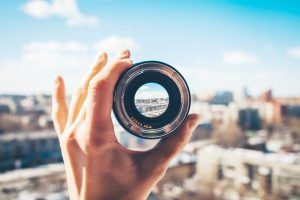 Hand holding a magnifying lens