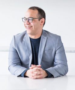 Male looking out a window smiling