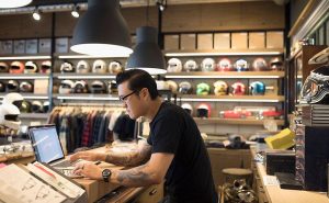 Business owner looking at computer screen inside their store