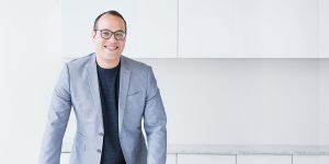 Smiling man wearing a blue blazer